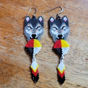 Handmade beaded medicine ball wolf earrings.